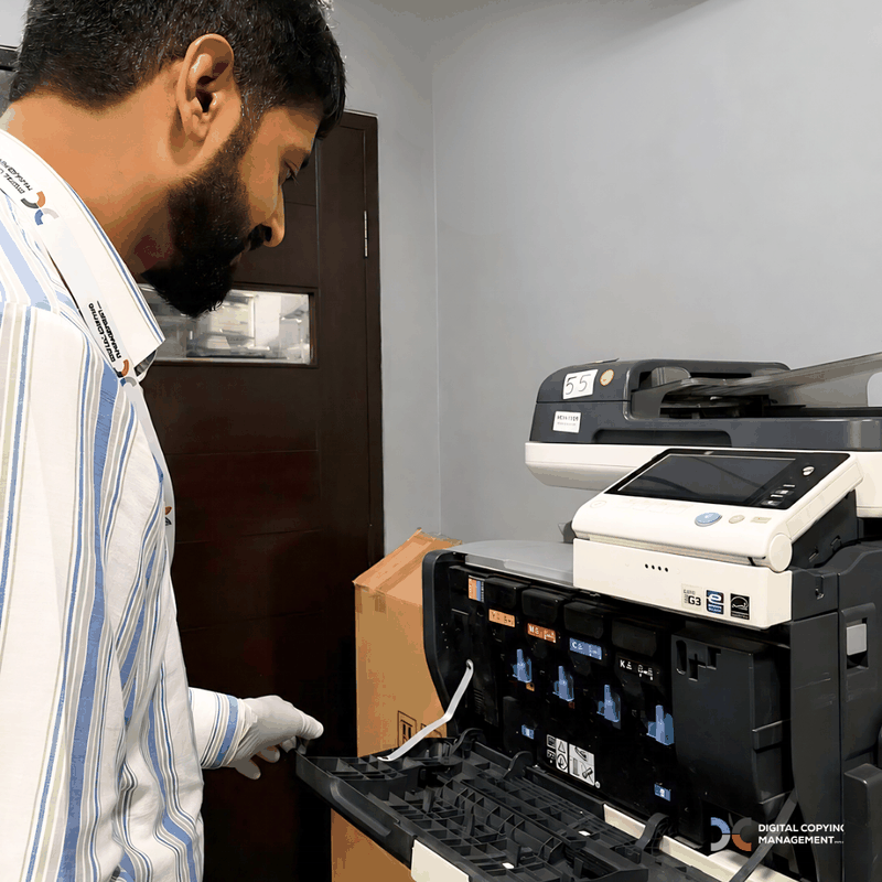 CMYK toner cartridge bay in colour copier maintained by DCM