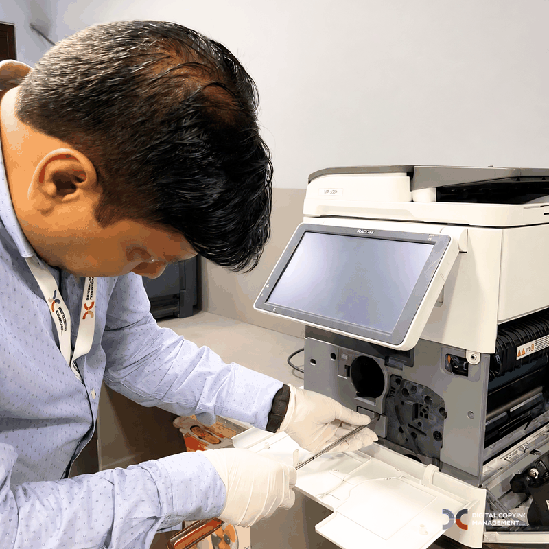 DCM engineer maintaining Ricoh copier